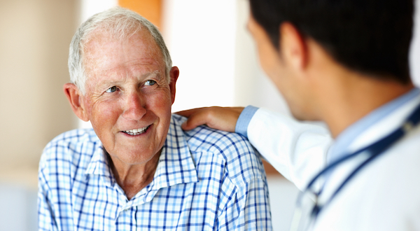 An older male patient talking to a doctor