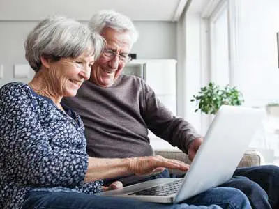 Man and woman taking an assessment on their computer