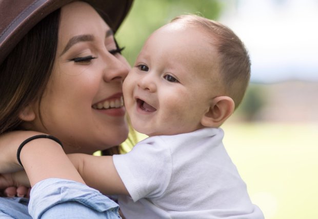 mother and son laughing during a sunny day (stock image)